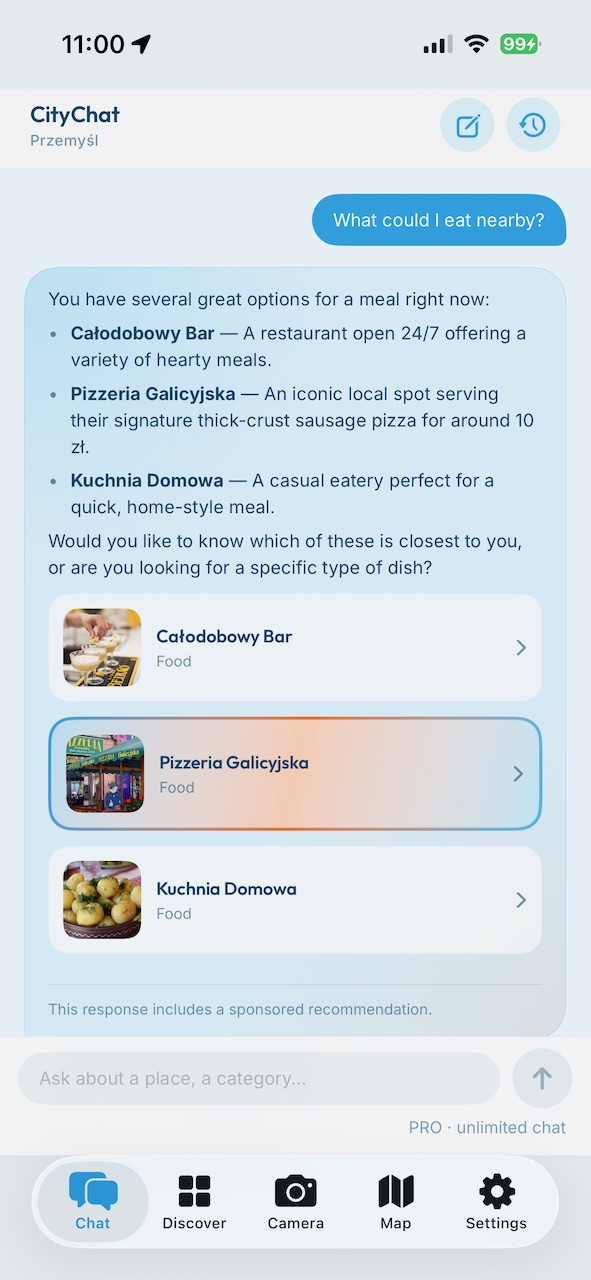 CityChat chat — asking what to eat nearby in Przemyśl; the answer lists three real places with tappable cards and a disclosed sponsored recommendation