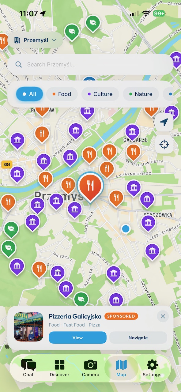 CityChat map — category pins across Przemyśl with a clearly labeled sponsored place preview